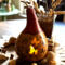 A gourd light with cat artwork on the front. Two butterfly cutouts show a battery-operated candle light shining through.